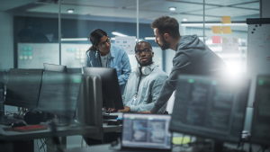 Three people in a small meeting